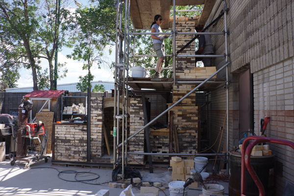 6 By the end of day 3, despite the 86°F (30°C) temperatures, the participants were close to completing the chimney. 