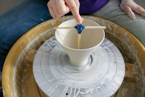 1 Throw a narrow bottomed V-shaped form. Use a T-shaped tool made from two chopsticks to gauge the height and diameter.