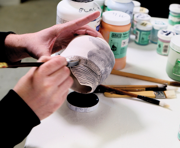 1 Apply a diluted black underglaze to the bisque-fired surface.
