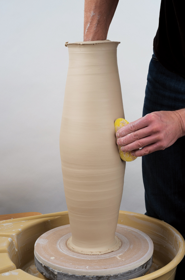 3 Support the inside of the cylinder with one hand, then smooth the exterior seam with a firm rib.