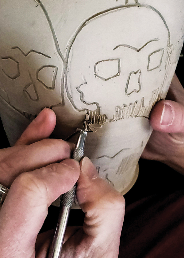 3 Using the same carving tool, carve into the areas where clay is to be removed.