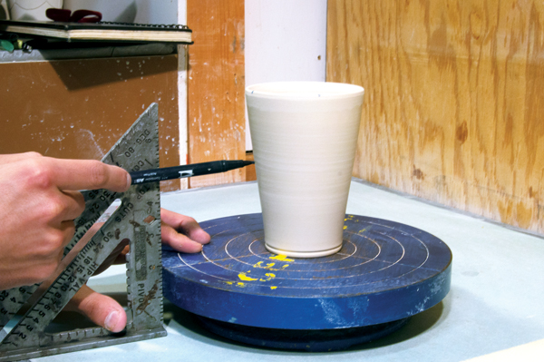 4 Use a square as a jig to mark the divided sections lower on the pot.