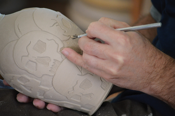 5 Continue to remove excess clay from the deepest relief areas, being careful to not pierce the form
