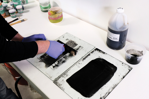 9 Lithography Stain Mixture (a mixture of Mason stain and linseed oil) is rolled onto the image.