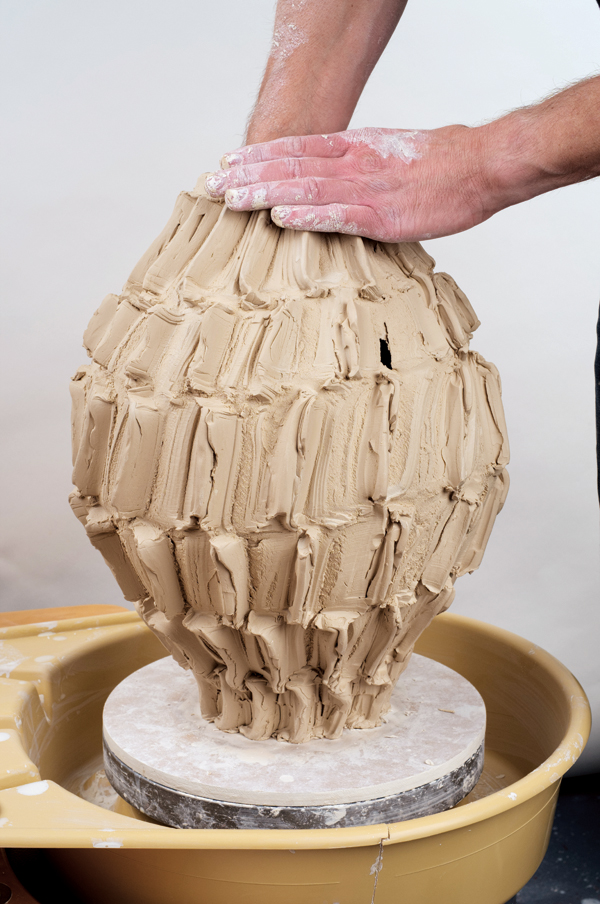 13 Continue by pulling the rib in an upward motion on the interior, turning the piece after every pull of the rib.