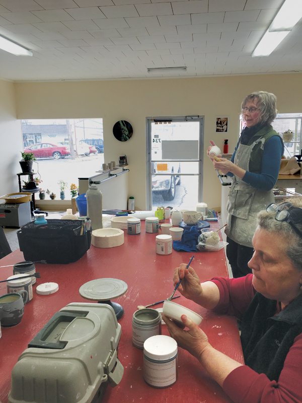 2 Participants in one of the small group classes at Bareclay, working on decorating vessel forms.