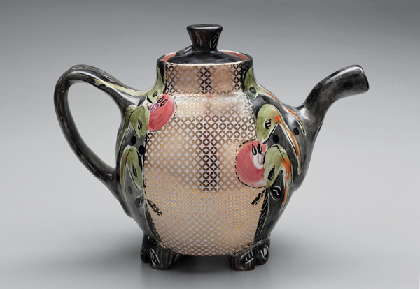 1 Posey Bacopoulos’ black oval teapot, 8½ in. (22 cm) in length, wheel-thrown, altered, and assembled earthenware, majolica, gold decal, 2018.