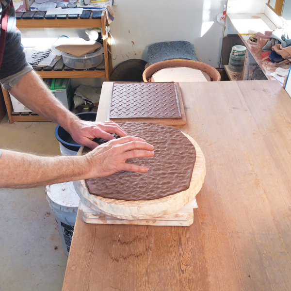 2 Tap the clay so it really gets into the nooks and crannies of the mold.