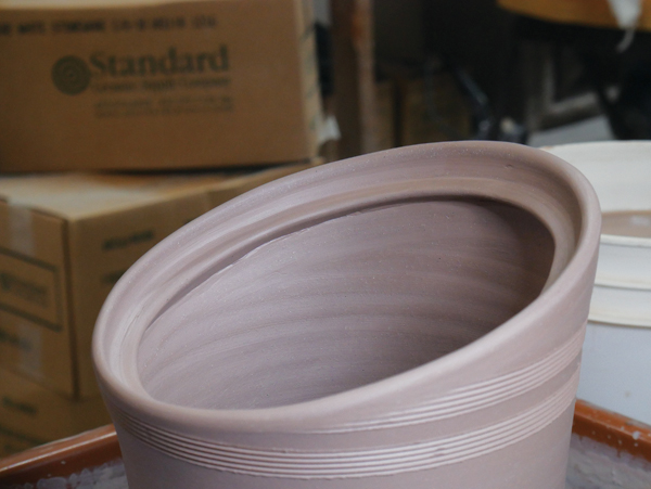 3 Attach and smooth a coil to the jar body to create a gallery.