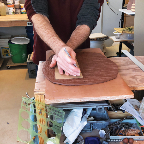 3 Cut around a template holding the knife at an angle to create a beveled edge.