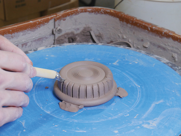 8 Carve vertical grooves in the thrown knob form.