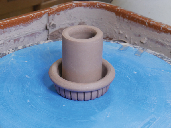 9 Attach the small cylinder to the inside of the recently carved knob.