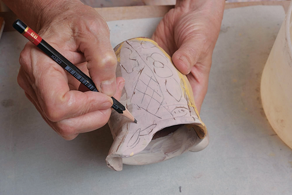 14 Following the sketch as a guide, carve lines into the surface of the slip using slightly more pressure on the pencil.