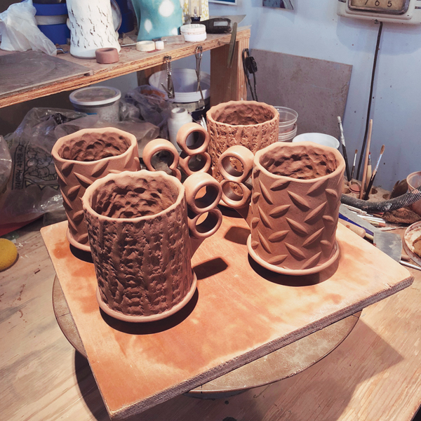 15 Finished mugs ready to dry evenly under plastic for a day or two.