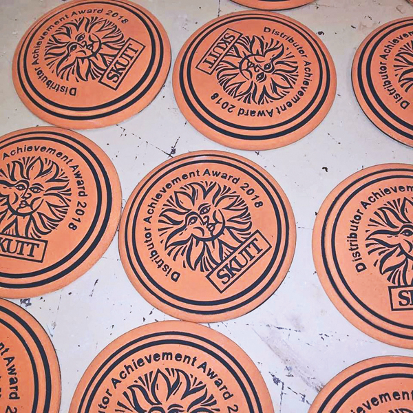 4 Fill recessed areas with black underglaze so the logo and text are easy to read.