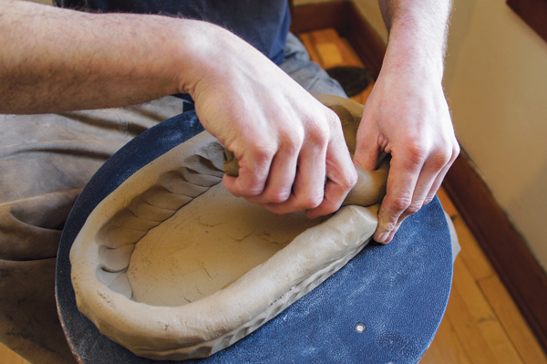 3 With the base formed, begin adding coils by pinching and connecting them to the base.