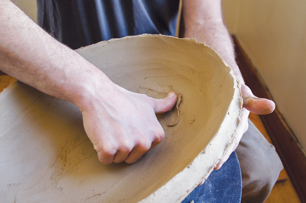 7 Once the walls are smooth, start to bring the walls out by pinching, stretching, and additional ribbing.