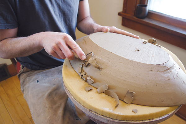 10 Flip the bowl onto foam once it’s stiff leather hard. Begin trimming and compressing the piece, making sure to balance the weight.