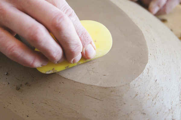 11 If a crack or void forms in the base as it is being trimmed, fill it with a recently trimmed piece of clay and compress with a rib.