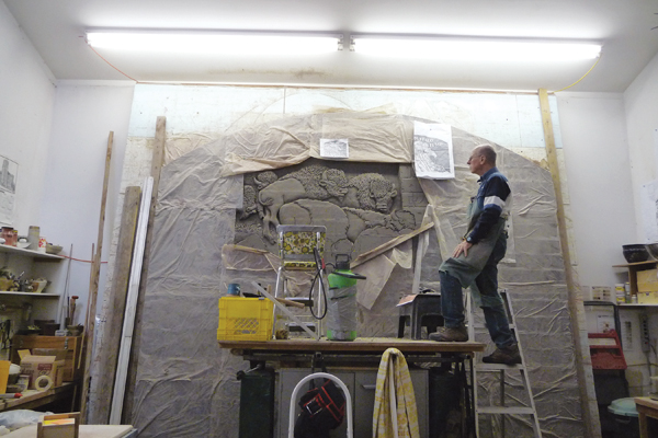 5 Carving a brick mural depicting a buffalo jump in Havre, Montana. The mural was installed in Havre near the 3000-year-old historic site and tourist attraction. 