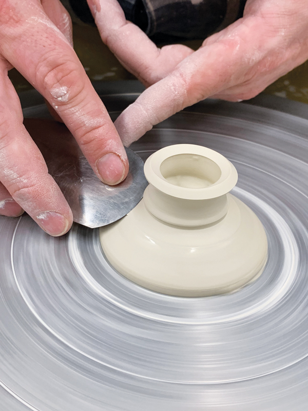 4 On the wheel, compress and smooth the trimmed surfaces.