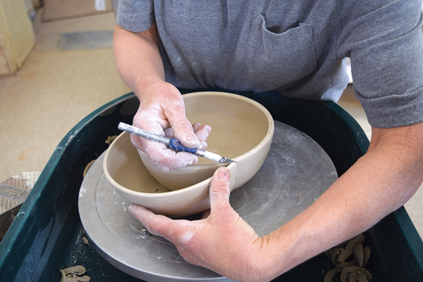 4 Position a half bowl against the side of the first bowl. Bevel the inner edge of the cut so it sits flat against the surface.