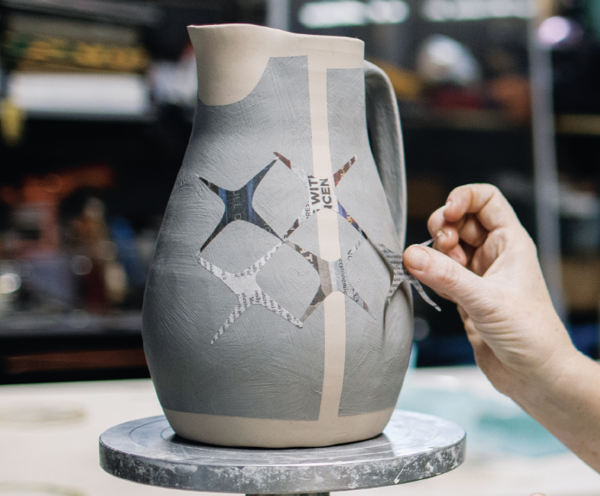7 Apply damp paper resist patterns to create a design across the pitcher’s surface.