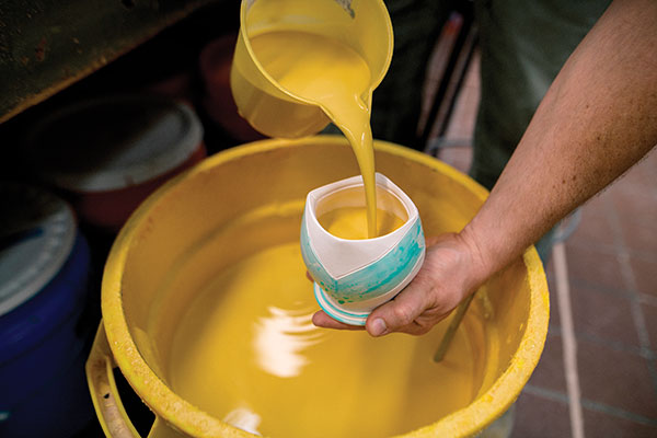 13 Glaze the interior first then rotate the cup while pouring the glaze out.