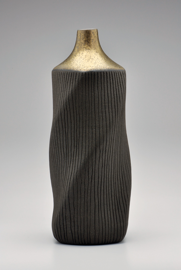 6 Twisted bottle, 18 in. (46 cm) in height, wheel-thrown stoneware, altered, carved, metallic glaze, fired to cone 6 in an electric kiln.
