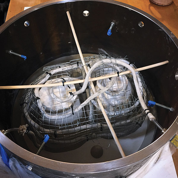 4 Detail of part 1 of a gang cup mold setup illustrating how the cotton mold duct gets connected to the air compressor fittings with clear tubing and zip ties.