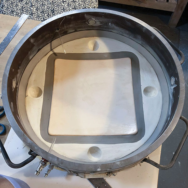 2 Setting up the second die casting of the interior of a square plate. The first half of the die is visible within the stacked steel frame.