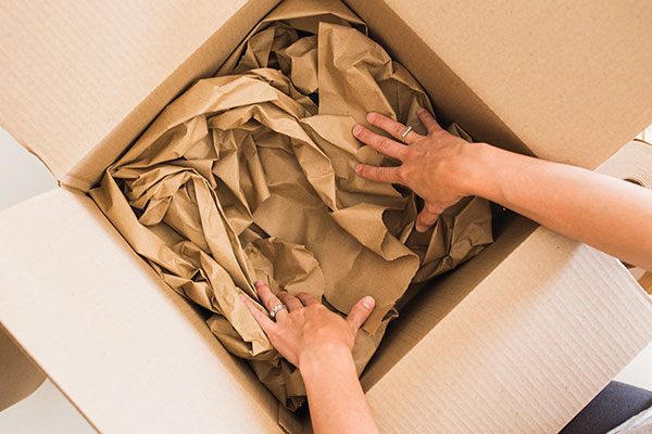 2 Create a nest of kraft-paper void fill in the bottom of the box. 