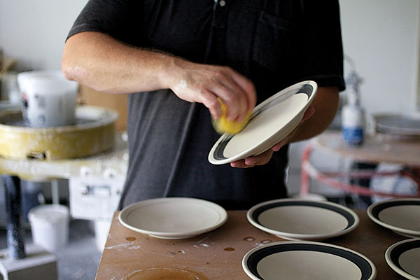 3 Keith Kreeger wiping away excess slip on the Gramercy dinnerware collection in his studio. Photo: Kate LeSueur.