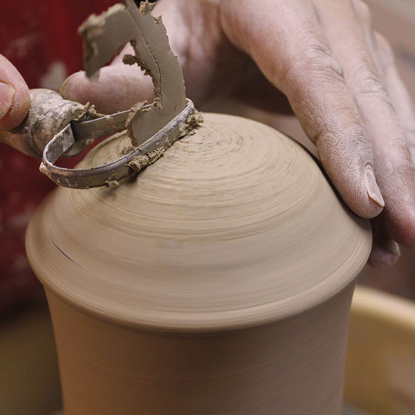 13 Remove the excess clay from the lid and create a smooth, curved dome.