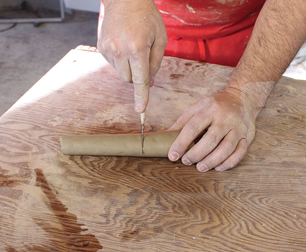 22 For the pulled-off-the-pot handle, roll a tapered coil and make a cut at the thick end.