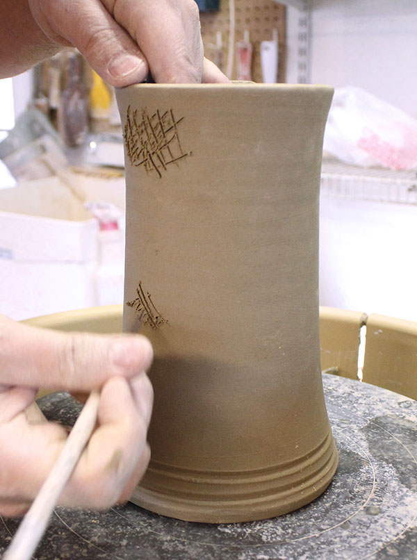 23 Score and add water to the two attachment points on the pot.