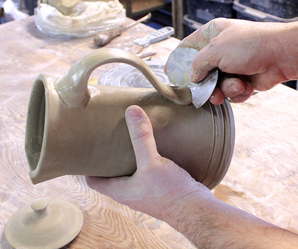 27 Cut the excess off the handle with a thin metal rib.