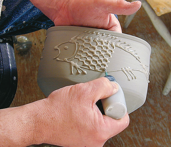 Slip trailing casting slip to create a low-relief, raised-line drawing. All photos: Judi Dyelle.