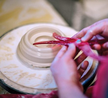 2 Compress a ball of clay with a wooden rib to make a thick saucer.