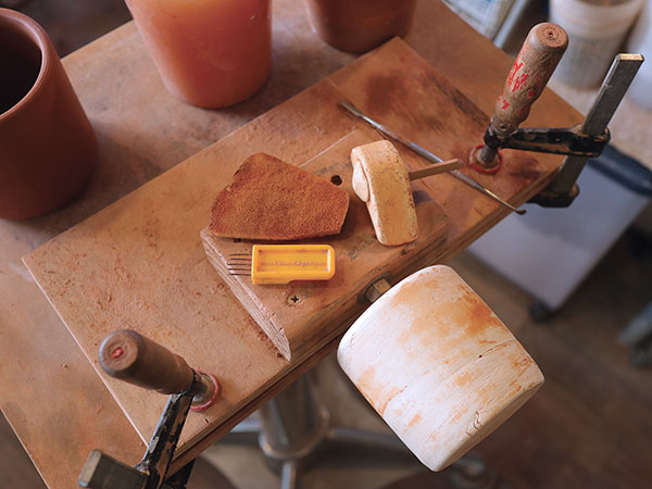 1 Mug assembly tools including plaster cylinder and handle forms.