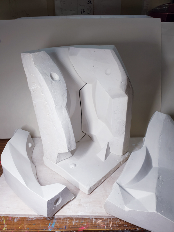  14 The finished 5-part plaster mold, shown partially assembled and with slip being added to cast a form. 