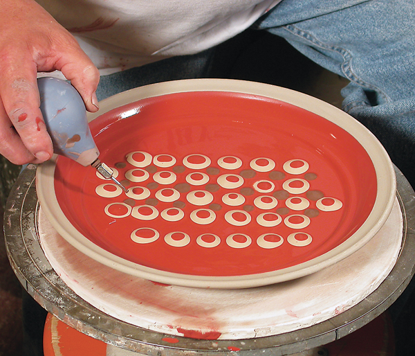 5 Dotting multi-colored slips into a pattern using a slip trailer.