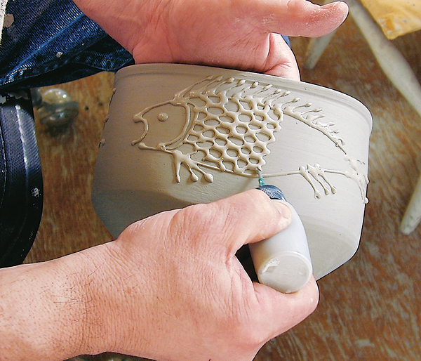 Slip trailing casting slip to create a low-relief, raised-line drawing. All photos: Judi Dyelle.
