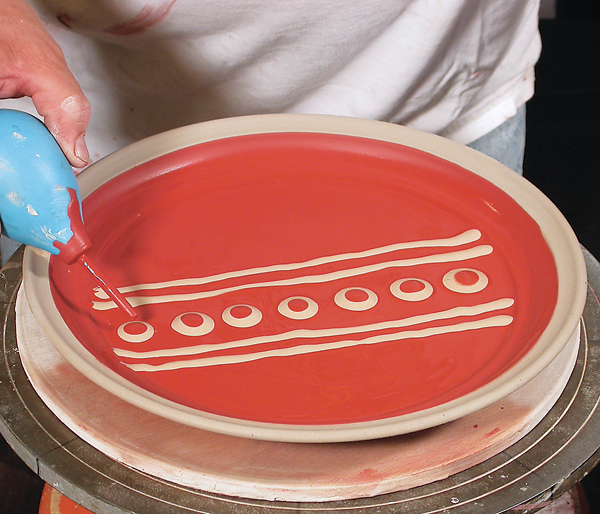 1 Dotting a multi-colored-slip pattern using a slip trailer.