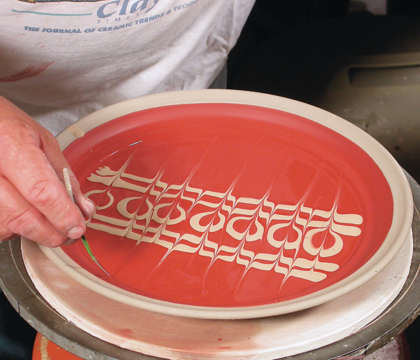 2 Feathering a dotted pattern using a thin piece of bamboo.