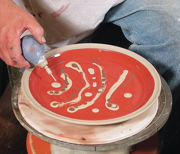 3 Preparing to marble by adding slips over an iron-colored slip.