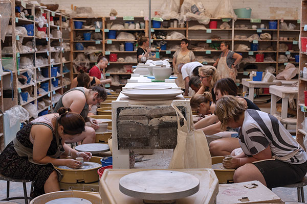 5 A full class of beginning/advanced beginning Lillstreet ceramics students working on the wheel. Photo: Courtesy of Lillstreet Art Center, Chicago.