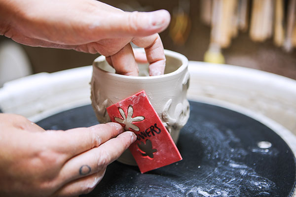 5 Arrange small stencils on the exterior to create details around the larger stencil.