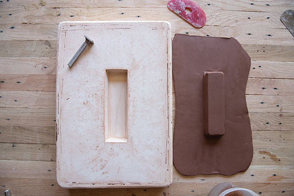 6 Remove the leather-hard slab from the mold used for the bottom of the butter dish. The inverted indent becomes a raised pedestal.