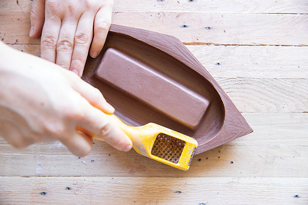 11 Use a Surform to begin refining the piece and to create sharp, precise edges. 